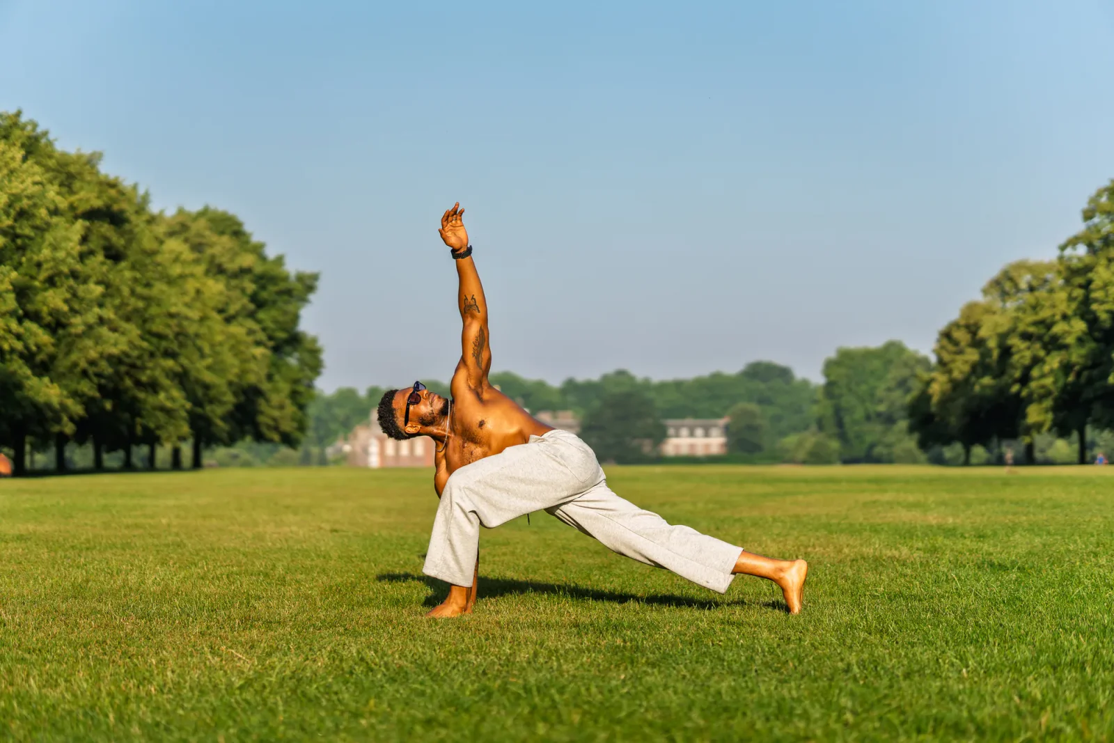 Josh Silvera holding a lunge stretch outdoors