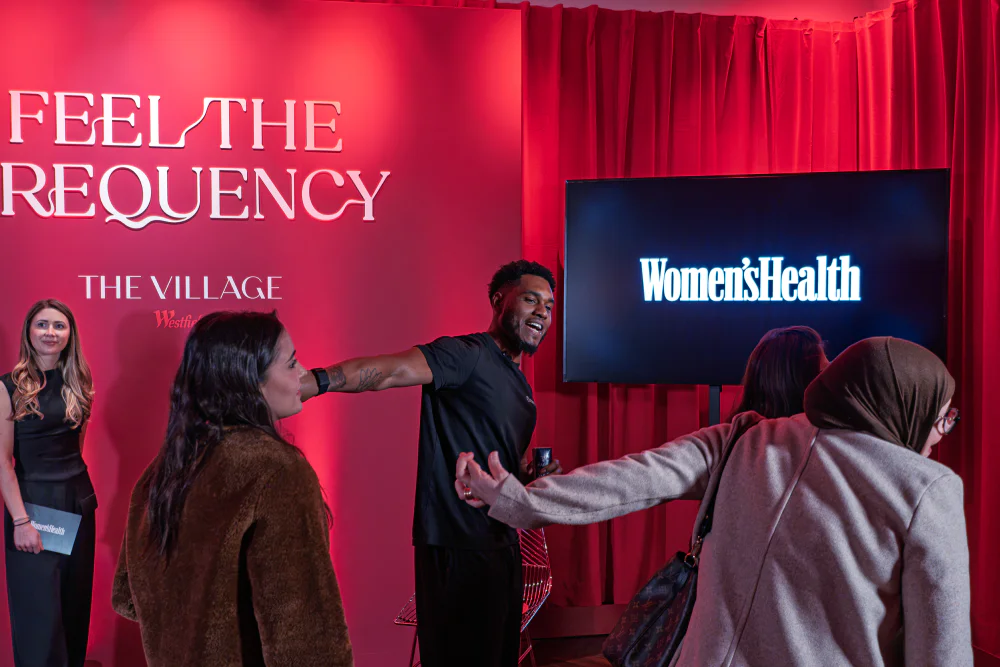 Josh Silvera showing attendees how to stretch an arm at the Women's Health event